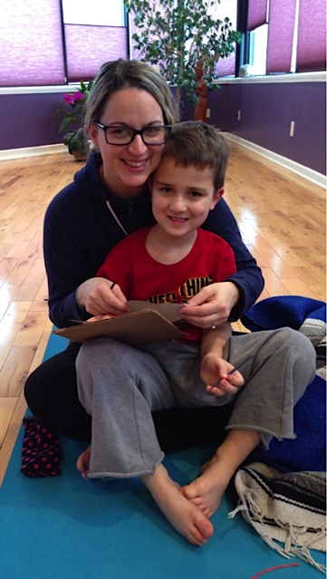 Parent and child sitting together on floor.